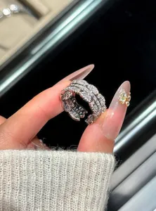 Detailed macro view of an exquisite multi-layered silver ring encrusted with clear zircons.