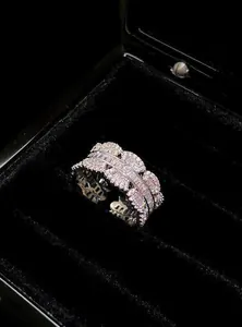 Detailed close-up of a sparkling silver fashion ring with layered cubic zirconia stones