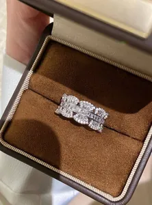 Macro view of a shimmering zircon ring with baguette stones in a premium brown gift box