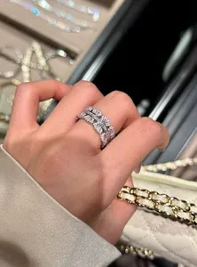 Close-up detail shot of a minimalist silver zirconia ring worn on the finger in luxury setting
