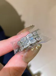Detail view of a silver ring set with sparkling zircons in a clear protective bag