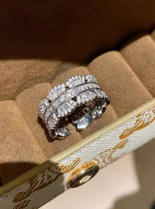 Close-up of luxury wide silver-toned ring with pavé and baguette cubic zirconia stones