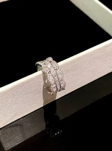 Detailed close-up of sparkling cubic zirconia silver ring on white display box edge