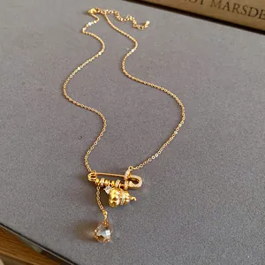 Close-up detail of 24k gold plated necklace with zircon gourd and crystal water drop pendants
