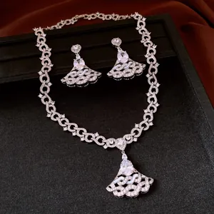 Detailed macro view of a luxury silver-toned jewelry set featuring zircon fan pendants