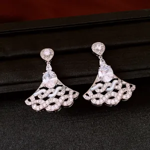 Close-up of elegant fan-shaped dangle earrings with sparkling oval zircons and silver finish.
