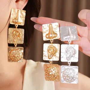 Avant-garde geometric square drop earrings with surrealist anatomical reliefs