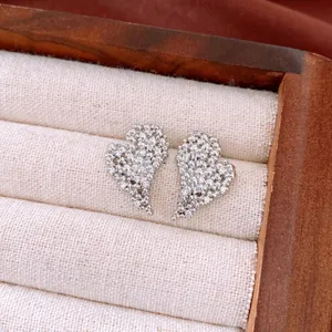 Detailed macro shot of sparkling heart-shaped stud earrings with cubic zirconia stones