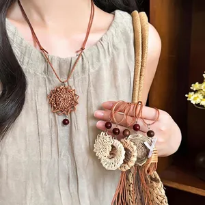 Elegant retro handmade woven rattan pendant necklace featuring a leather cord and beads.