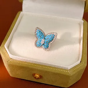 Elegant blue butterfly ear clip inlaid with zircon stones in a green velvet gift box