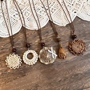 Handmade bohemian wicker pendant necklaces with leather cords and wooden beads.