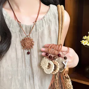Detailed macro view of handmade vintage rattan woven pendant necklaces with leather cord