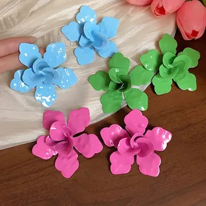 Vibrant oversized enamel flower stud earrings set in blue, green, and pink colors