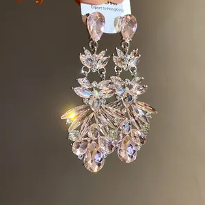 Close-up of pink crystal water-drop chandelier earrings with elegant silver needle.