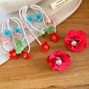 Detailed view showing multi-colored beaded flower tassel earrings and pearl studs