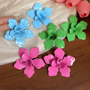 Detailed view of large enamel flower earrings in vibrant colors
