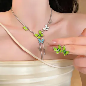 Elegant green enamel butterfly necklace and earring set with sparkling rhinestones