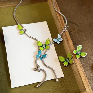 Detailed view of forest style enamel butterfly necklace and matching stud earrings set