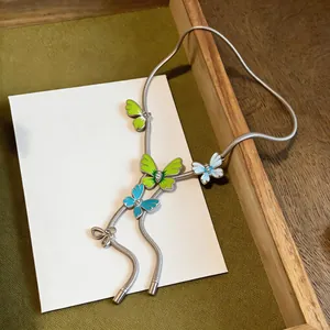 Detailed shot of multi-color enamel butterfly necklace on a silver-tone snake chain.