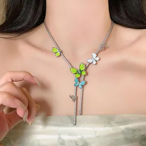 Elegant silver-toned Y-shaped necklace with colorful enamel butterfly charms on model