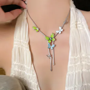 Detail of butterfly necklace with colorful enamel pendants on silver snake chain