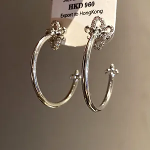 Elegant silver needle fleur-de-lis C-shaped earrings with sparkling cubic zirconia inlay