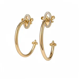 Elegant gold Fleur-de-lis C-shaped hoop earrings with sparkling clear zirconia stones