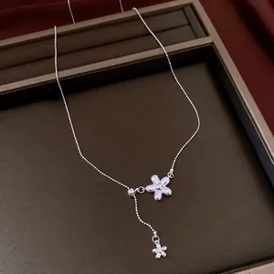Elegant silver flower tassel necklace with minimalist chic design and Y-shaped chain for women