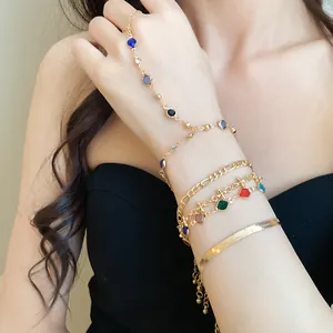 Close-up detail of a five-piece gold bracelet set featuring colorful crystal beads
