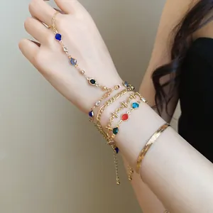 Elegant close-up of layered gold-tone bracelet set featuring colorful crystals on a wrist