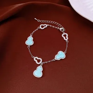 Elegant 18k gold plated zircon hulu bracelet featuring light blue acetate charms for women