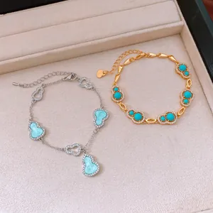 Detailed close-up view of elegant 18k gold plated zircon hulu gourd bracelets in a tray