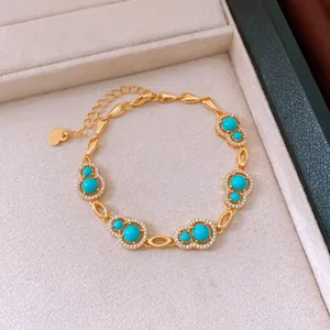 Close-up of gold-plated hulu bracelet with turquoise stones and zirconia in a jewelry box