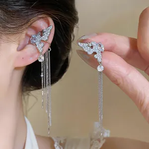 Macro detail of long tassel zircon ear cuff showing sparkling crystals and silver finish