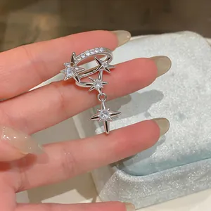 Detailed close-up view of a silver star-shaped ear cuff with zircon tassel for women