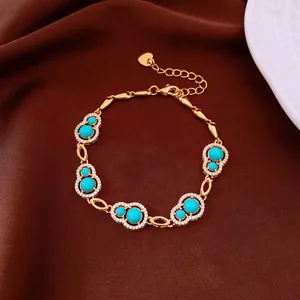 Detail of gold-plated hulu bracelet featuring vibrant turquoise stones and shiny zircons