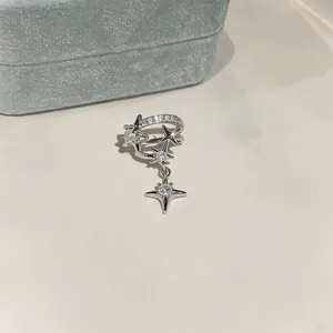 Close-up view of silver star ear cuff with clear cubic zirconia stones and dangling star