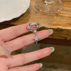 Detailed close-up of a silver double-layer ear cuff featuring zircon stars and tassel