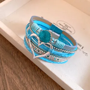 Detailed close-up of a blue multi-layer bohemian wrap bracelet with a silver heart