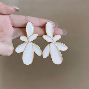 Exaggerated white enamel flower earrings with gold-toned metal edges for women