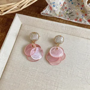 Elegant pink cat-eye shell tassel earrings with gold mesh beads, Korean style.