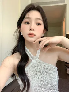 Elegant romantic zircon hollow floral basket pearl earrings shown on an Asian model