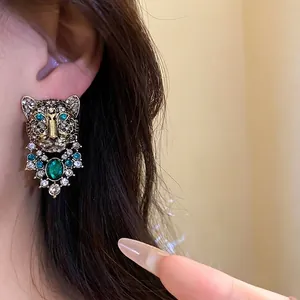 Vintage leopard head stud earrings with emerald crystals and gold finish