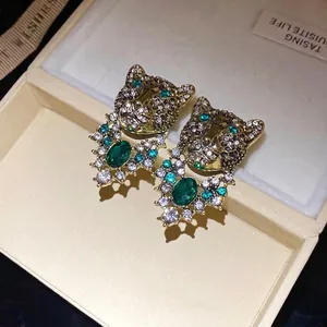 Vintage leopard head stud earrings with emerald green crystals and rhinestones