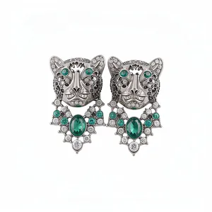 Vintage leopard head stud earrings with green rhinestones and silver pins