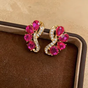 Macro view of elegant red teardrop gemstone earrings with gold-toned plating