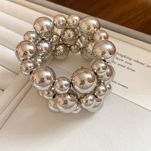 Detail of a vintage silver metallic beaded bracelet set with high-gloss polished finish.