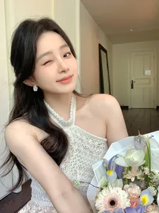 Close-up of elegant model wearing hollow flower basket pearl earrings with zircon