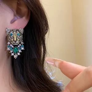 Vintage style leopard head stud earrings featuring green gemstones and crystal rhinestones