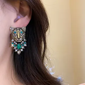 Exquisite vintage leopard head stud earrings with green rhinestones and crystal details